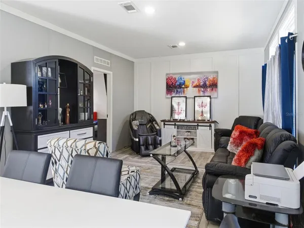 a living room with furniture a air conditioner and a window