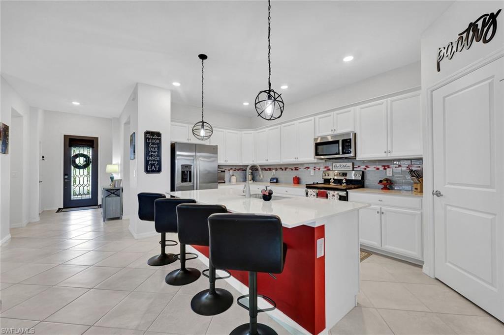 2622 Scarlet Way Naples, FL 34120 - Photo 3 of 24 a view of kitchen with cabinets and outdoor seating