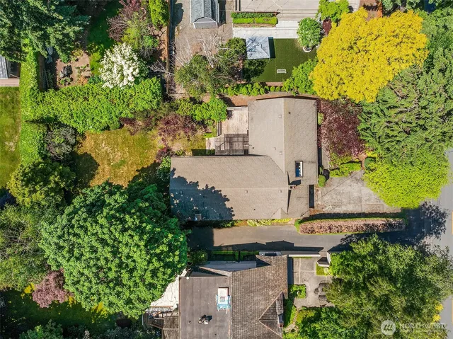 an aerial view of a house with swimming pool and garden