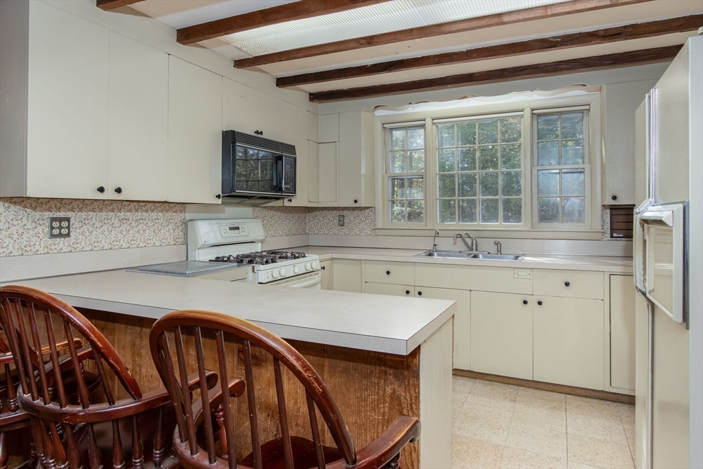 436 Main Street Groton, MA 01450 - Photo 13 of 39 a kitchen with stainless steel appliances granite countertop a sink microwave and cabinets
