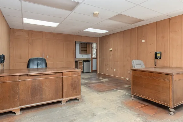 a view of a workspace with furniture and a window