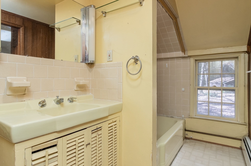 436 Main Street Groton, MA 01450 - Photo 24 of 39 a bathroom with a sink a mirror and a bathtub