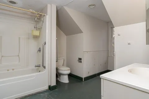 a kitchen with granite countertop a sink stove and refrigerator