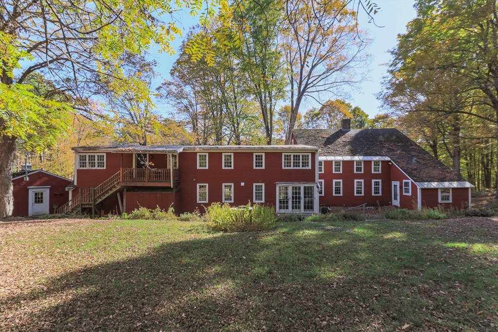 436 Main Street Groton, MA 01450 - Photo 3 of 39 a view of a yard in front of a house with large tree