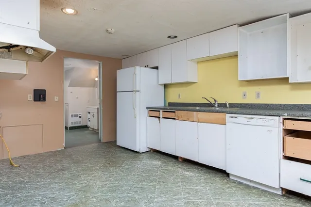 a kitchen with counter top space and windows