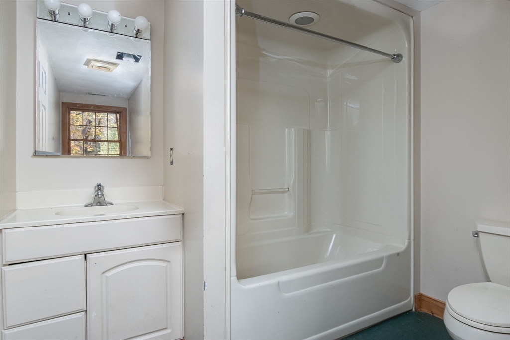 436 Main Street Groton, MA 01450 - Photo 34 of 39 a bathroom with a sink a toilet and shower