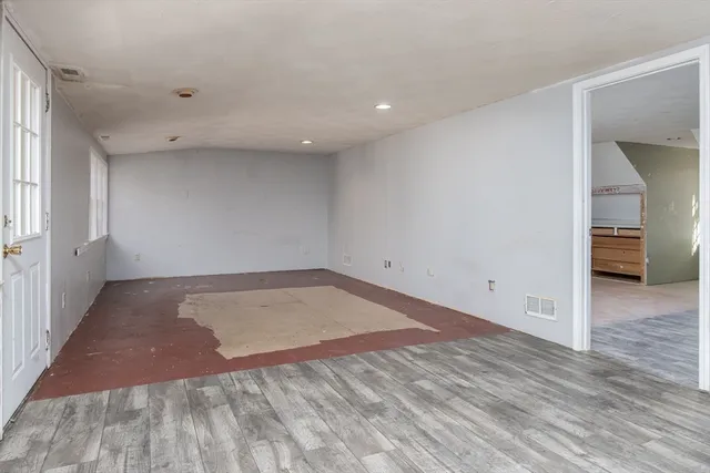 an empty room with furniture and window