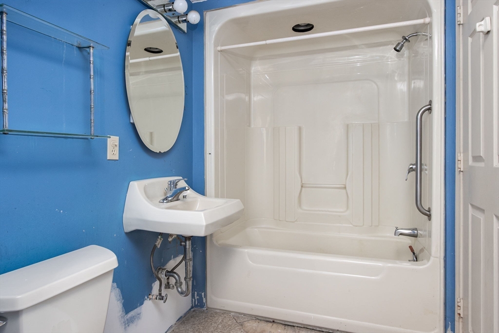 436 Main Street Groton, MA 01450 - Photo 37 of 39 a bathroom with a sink a toilet and a mirror