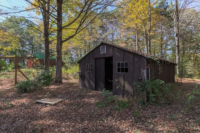 a yellow house in middle of the forest