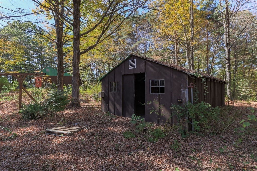 436 Main Street Groton, MA 01450 - Photo 9 of 39 a yellow house in middle of the forest