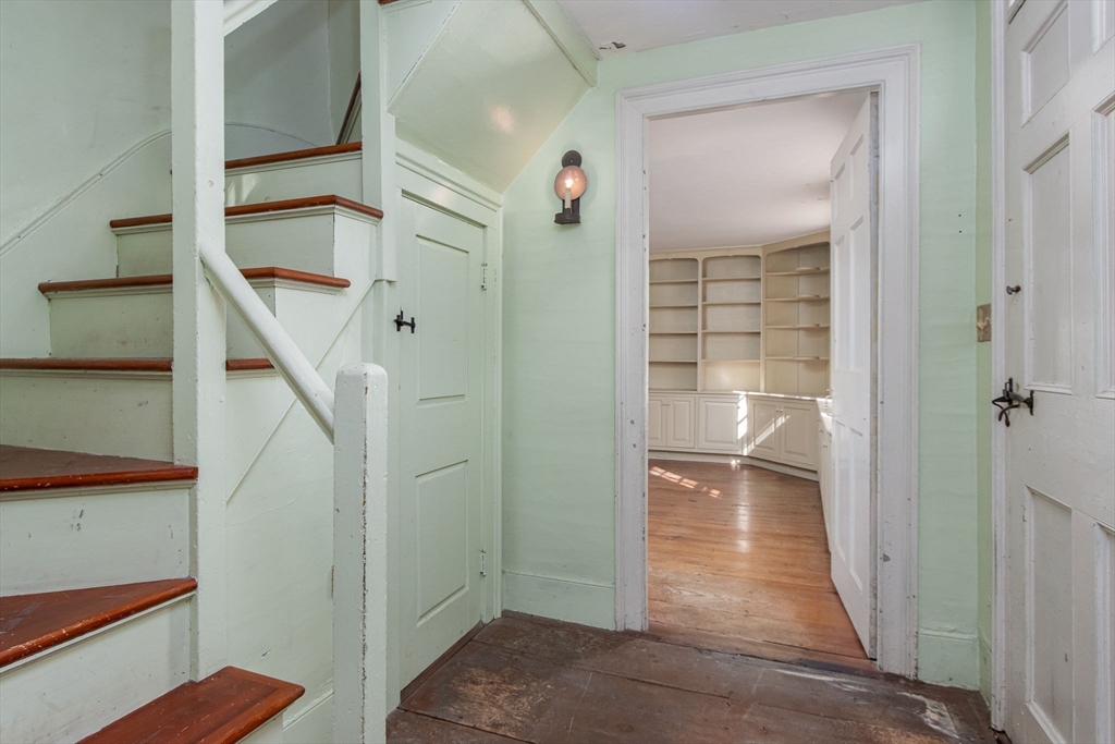 436 Main Street Groton, MA 01450 - Photo 10 of 39 a view of a hallway with wooden floor and staircase
