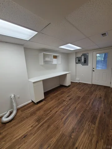 a room with wooden floor and furniture