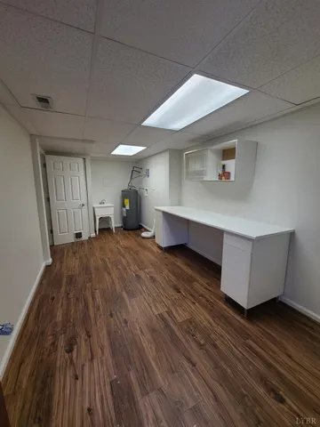 a room with wooden floor and furniture