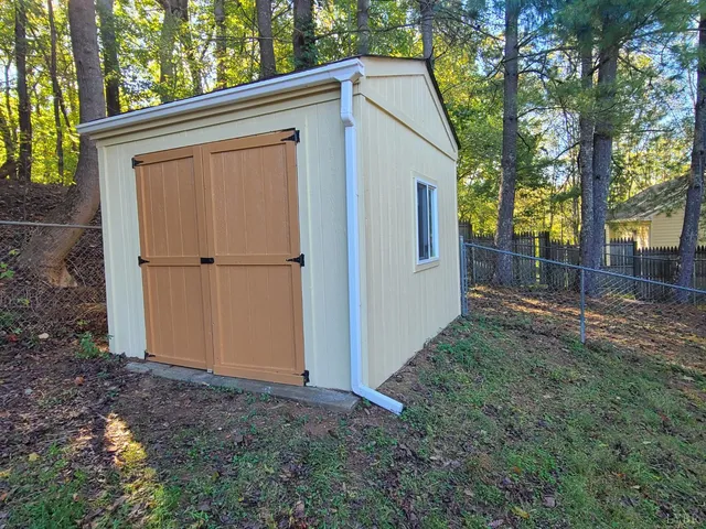 a view of a backyard with large tree