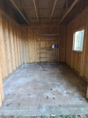a view of a empty room with a garage