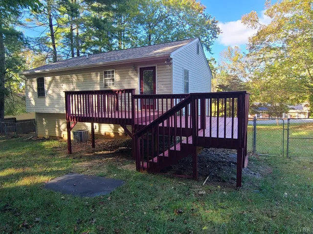 a view of a chair and table in backyard of the house