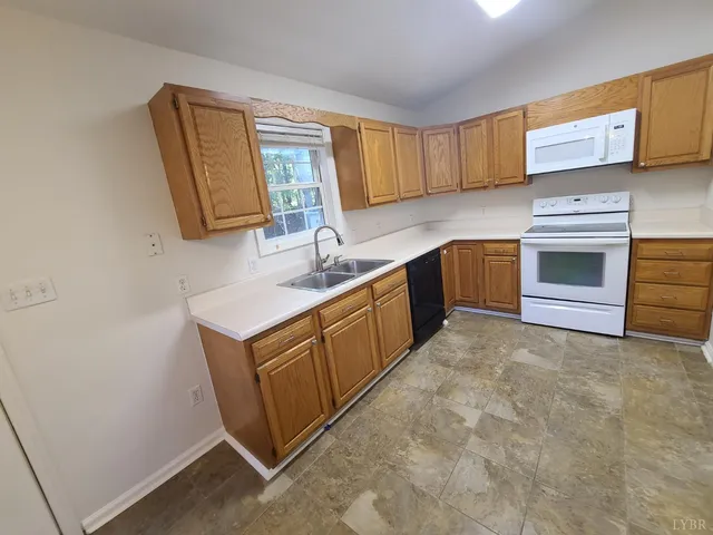 a kitchen with stainless steel appliances granite countertop a sink stove and microwave