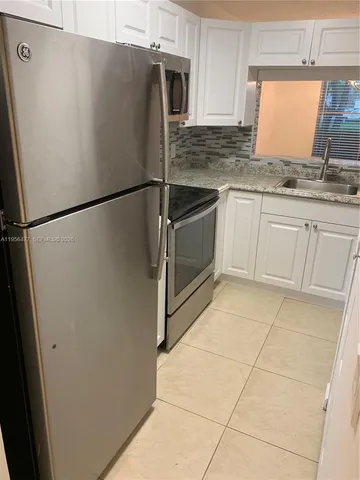 a white refrigerator freezer sitting inside of a kitchen