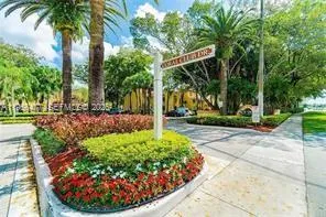 a view of a swimming pool with lawn chairs under an umbrella