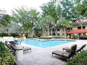 a view of a swimming pool with an outdoor space and seating area
