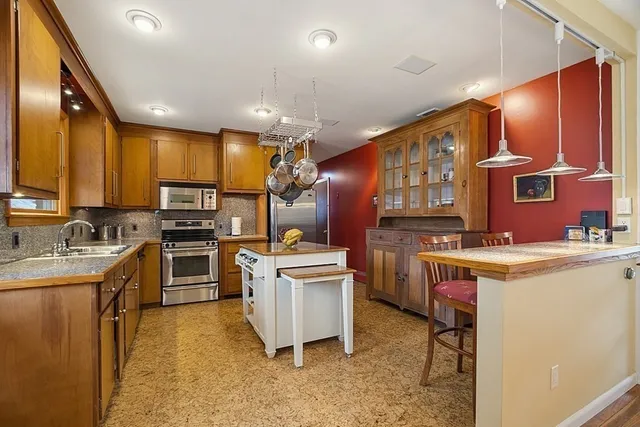 a kitchen with cabinets a sink and appliances