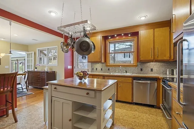 a kitchen with a sink stove and cabinets