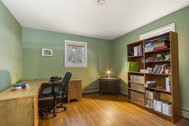 a view of a workspace with furniture and cabinet