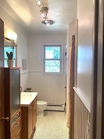 a bathroom with a sink toilet and shower