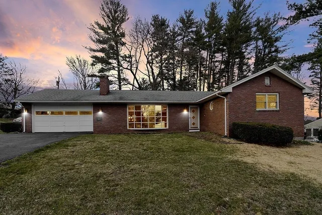 a view of a house with a yard and garage