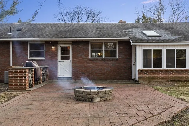 a front view of a house with glass windows and yard