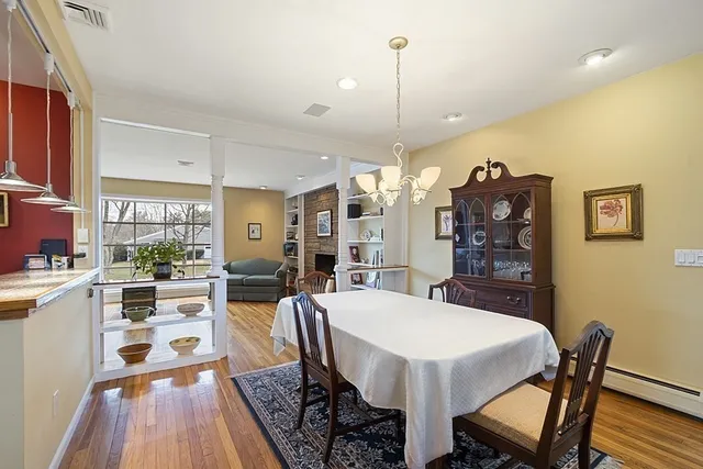 a view of a dining room with furniture window and wooden floor