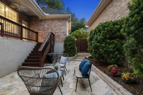 a backyard of a house with table and chairs