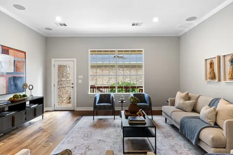 a living room with furniture and wooden floor