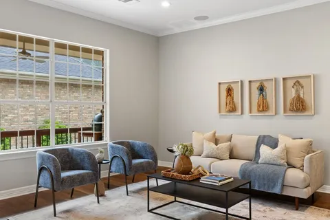 a living room with furniture and wooden floor