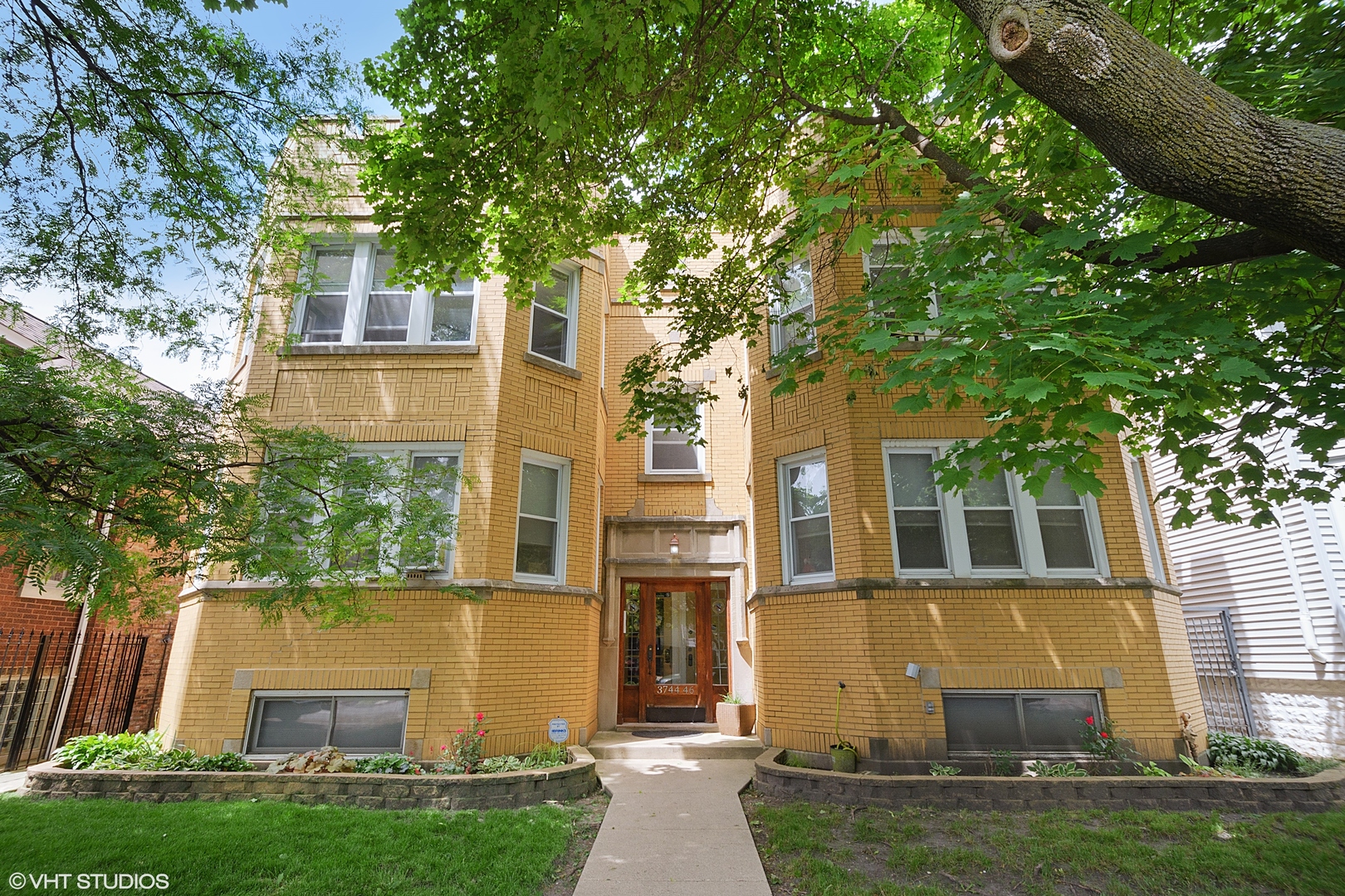 3746 North Whipple Street, Unit 2 Chicago, IL 60618 - Photo 2 of 22 front view of house with a yard