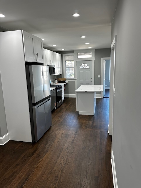3746 North Whipple Street, Unit 2 Chicago, IL 60618 - Photo 10 of 22 a view of kitchen with stainless steel appliances refrigerator stove microwave and cabinets