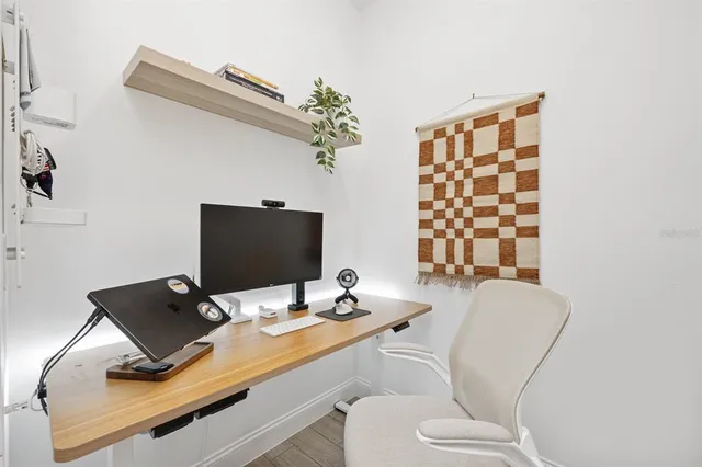 a hallway with front door wooden floor and windows