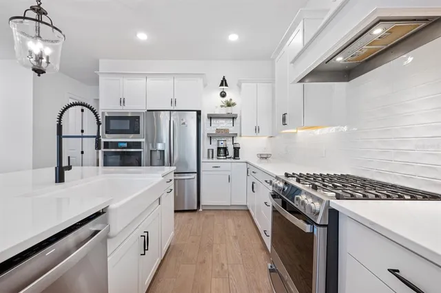 a kitchen with stainless steel appliances a refrigerator sink and cabinets