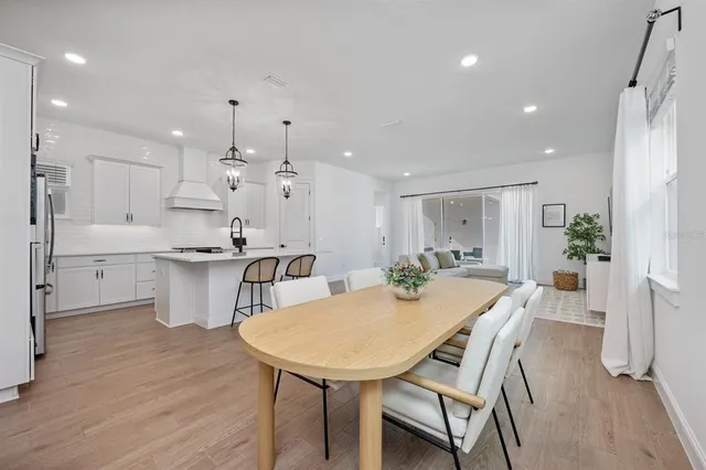 a view of a dining room with furniture and wooden floor
