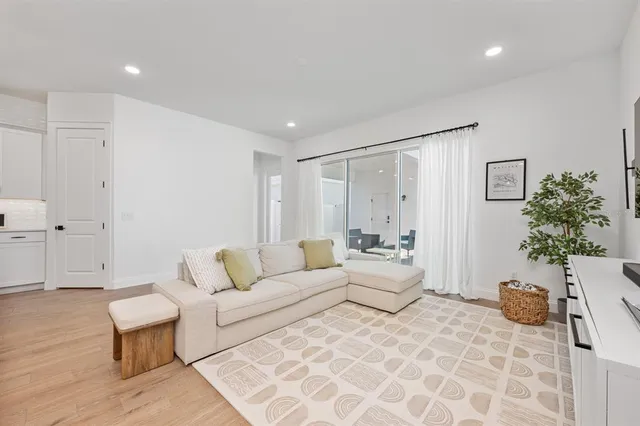 a living room with furniture and wooden floor