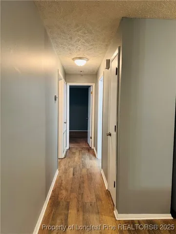 a view of hallway with wooden floor