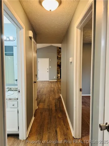 a view of a hallway with wooden floor