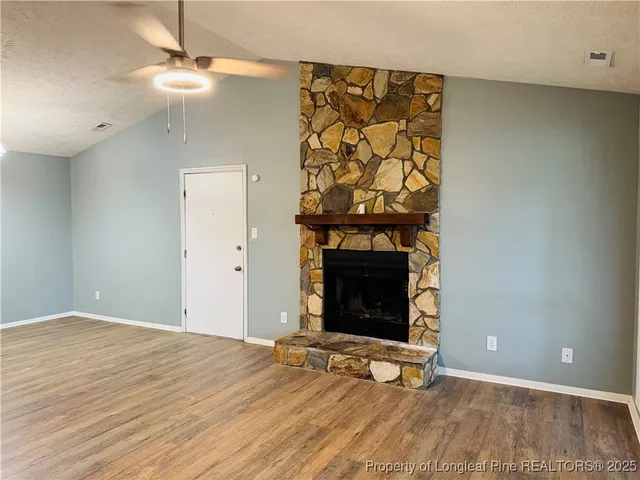 wooden floor with fireplace and a wooden floor