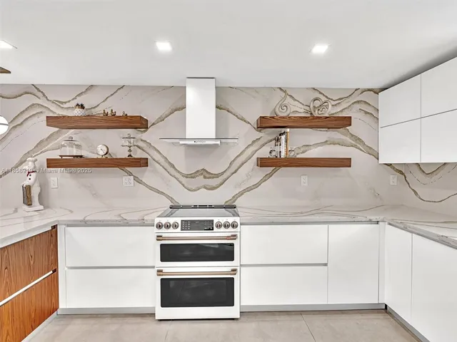 a kitchen with stainless steel appliances kitchen island granite countertop a table and chairs in it