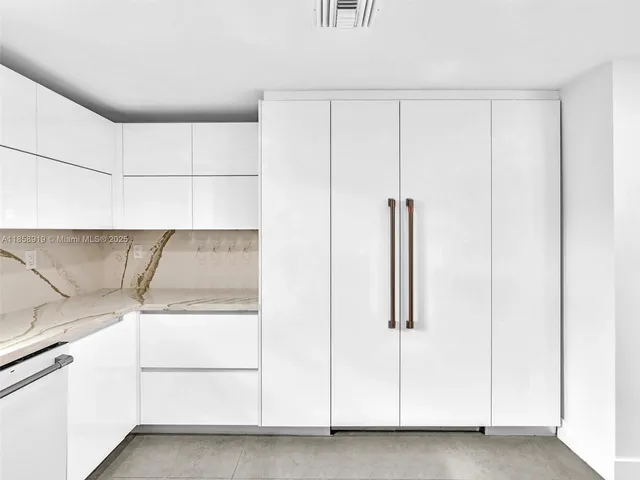 a living room with dining room and chandelier