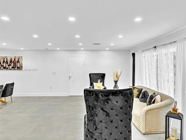 a workspace with furniture and a view of kitchen