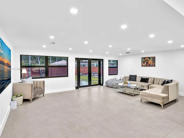a bathroom with a granite countertop sink a toilet a mirror and shower