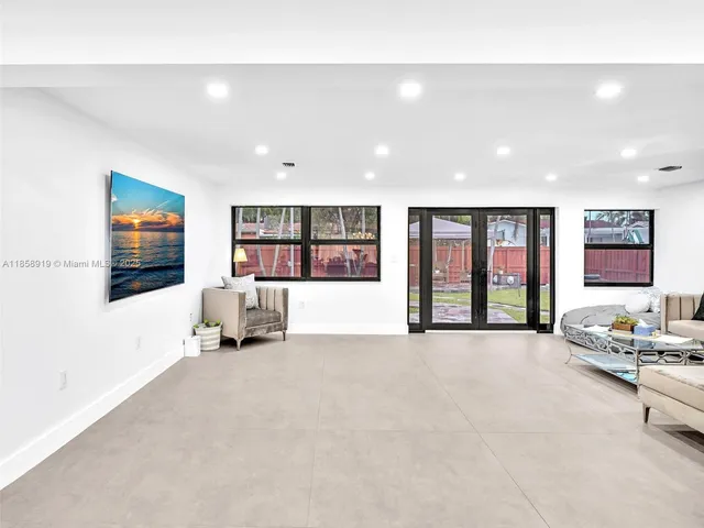a spacious bathroom with a double vanity sink a mirror and a shower