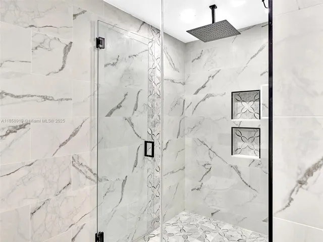 a bathroom with a sink a mirror and a shower