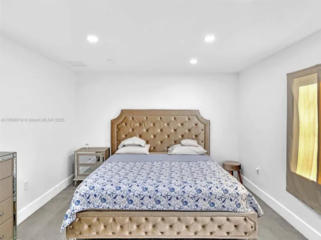 an aerial view of a house with a garden and trees